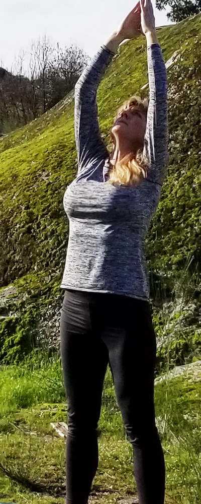 Joanie in salutation yoga pose in Portugal
