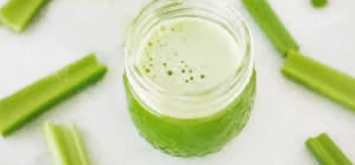 celery sticks and celery juice in a glass